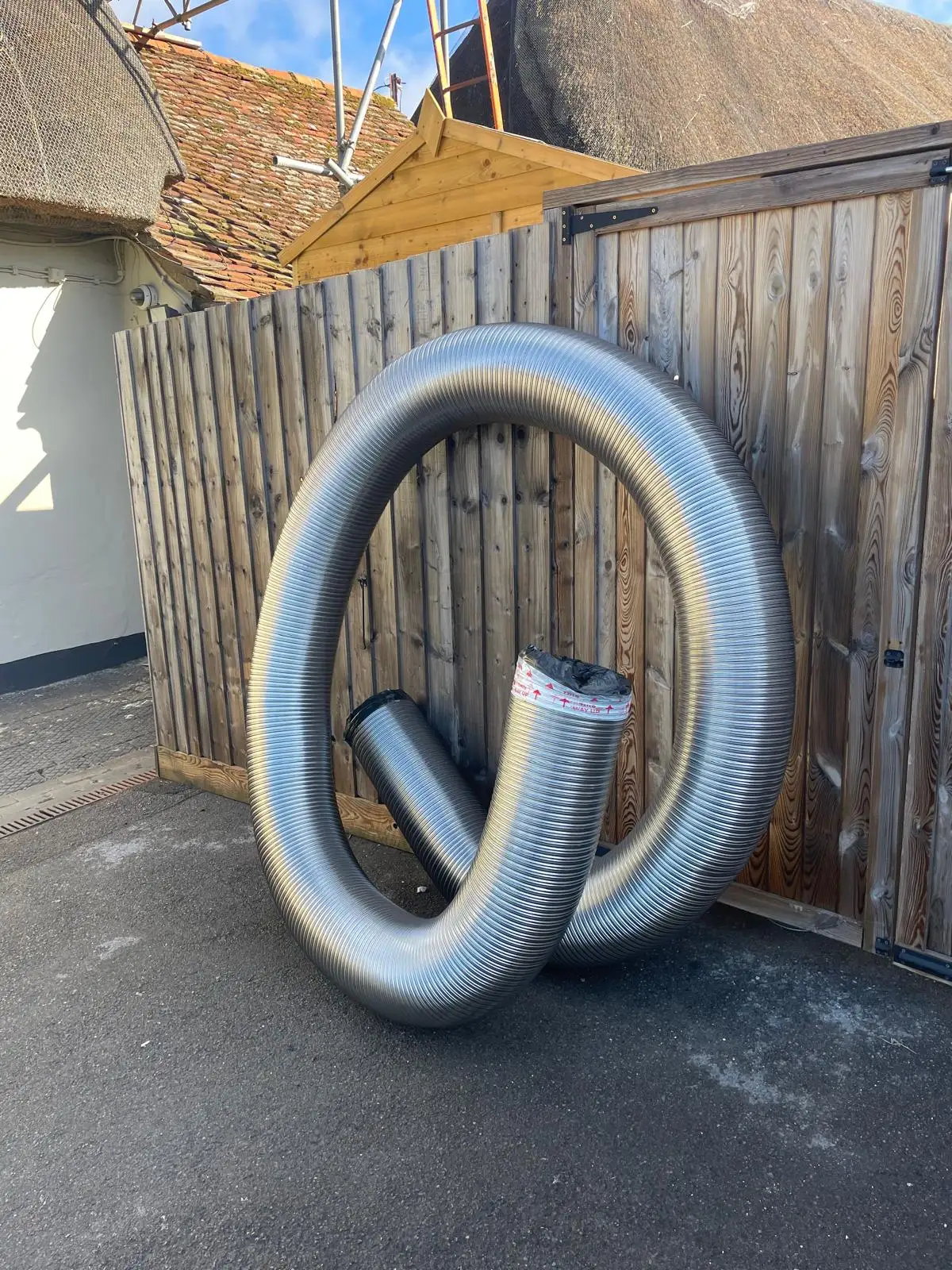 The flue liner, coiled and waiting to go in