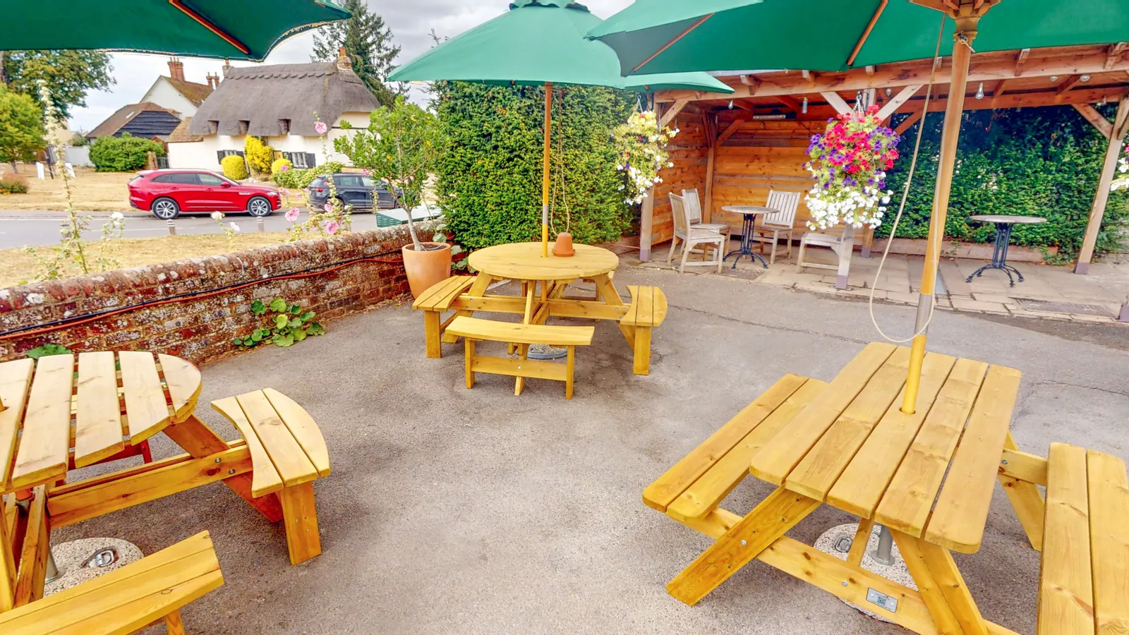 Benches and parasols in the garden at The Crown