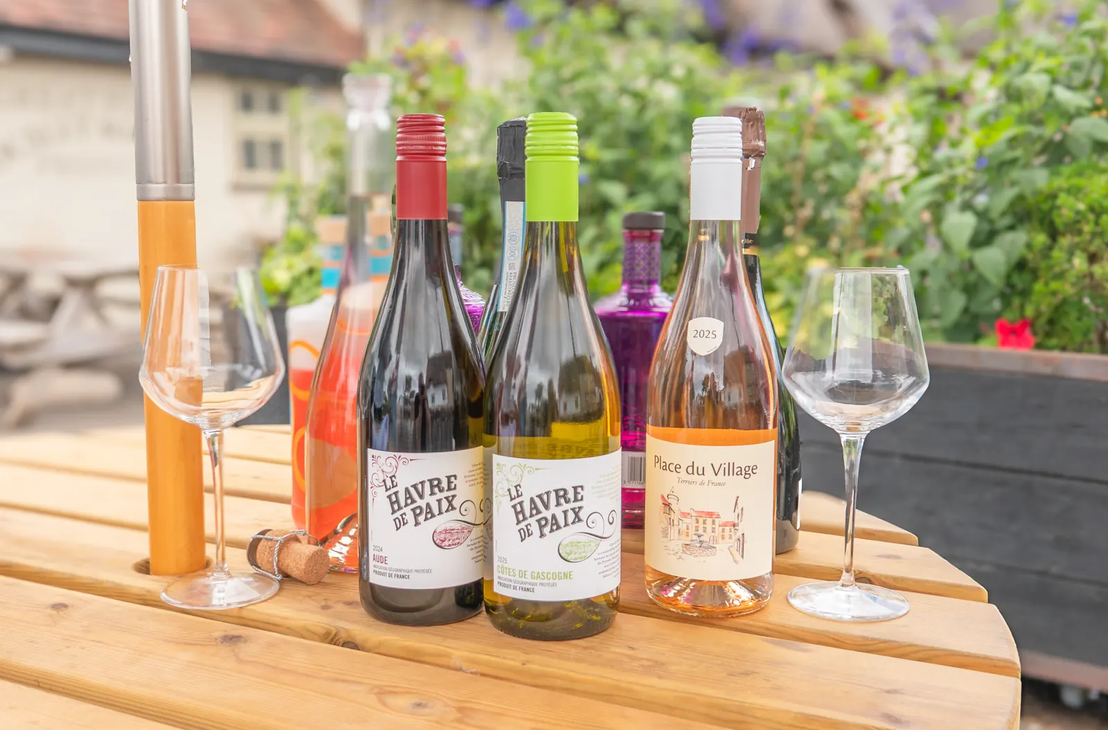 Bottles of house red, white and rosé wine with glasses