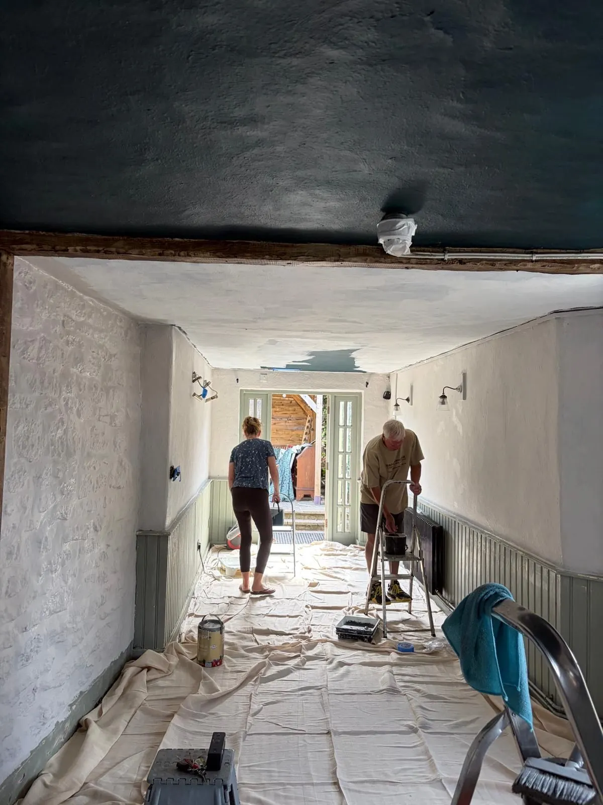 Two coats and a dark ceiling