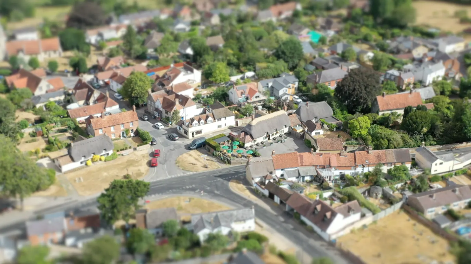 Cuddington seen from the air, with The Crown and its thatched roof at the centre of the village