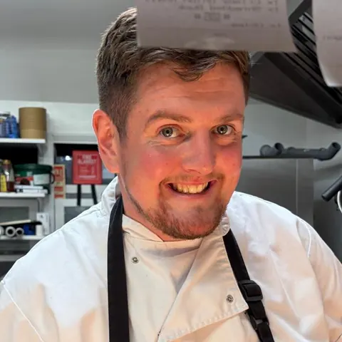 Nick Henderson, chef at The Crown, in chef whites in the kitchen